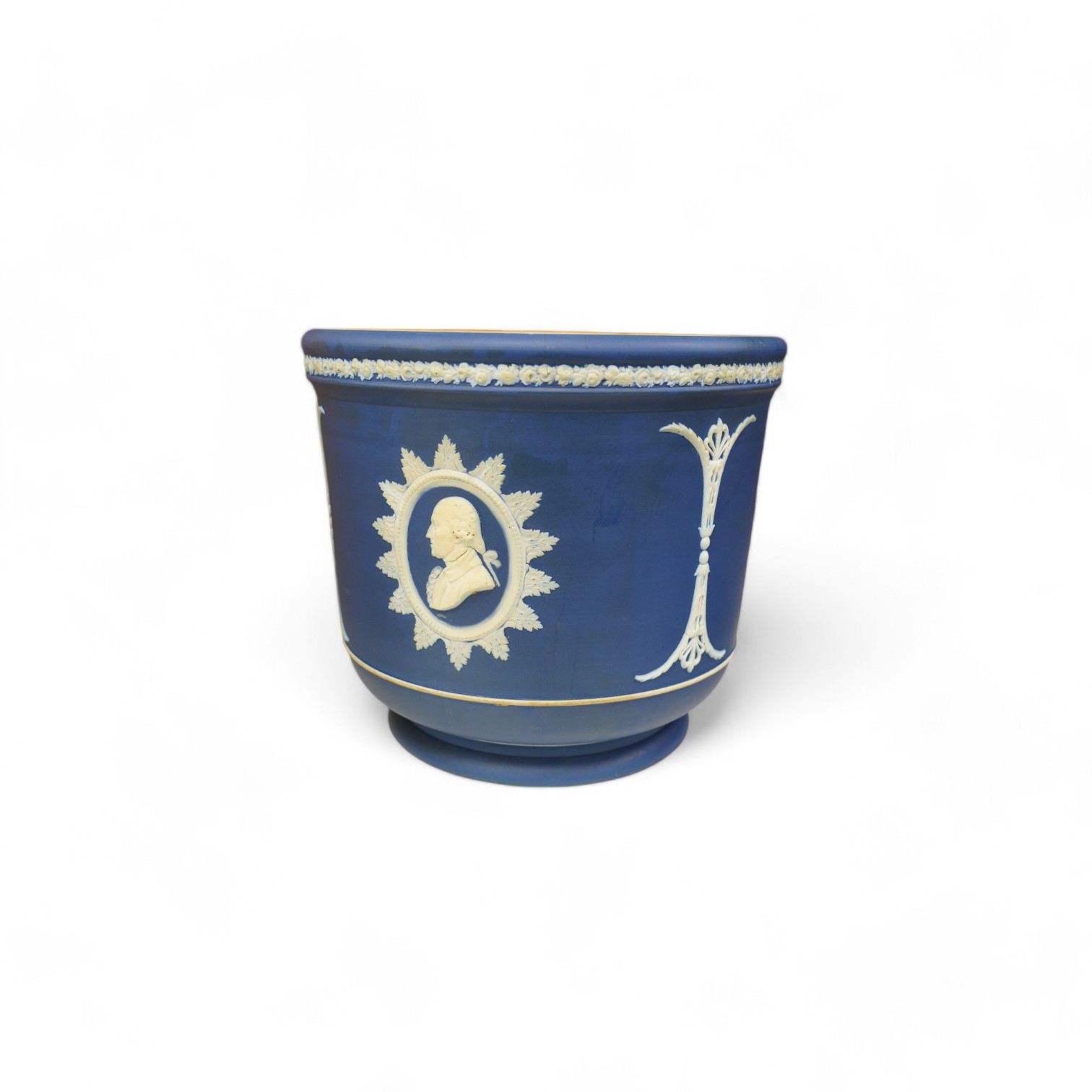 A Wedgwood Jasperware jardiniere decorated with the founding fathers (USA), height 21cm. Condition - fair, the surface has a few fine scratches and a small hairline crack to rim of base